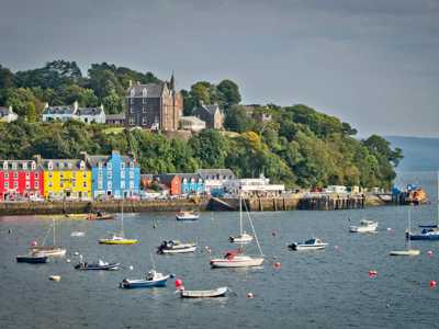 Tobermory’s vibrant waterfront with colourful buildings lining the harbour, reflecting on calm waters