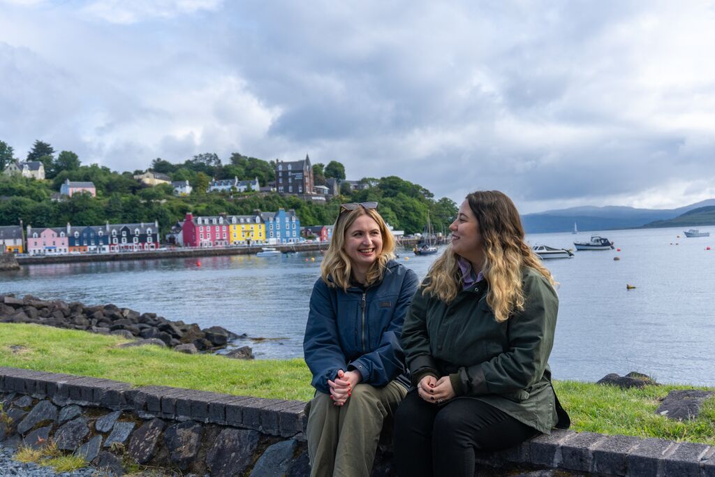 Two friends relaxing by the colourful harbour in Tobermory