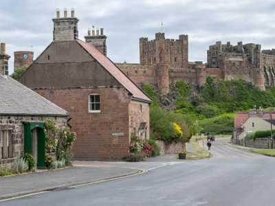 Bamburgh village with its quaint stone houses and Bamburgh Castle towering in the distance